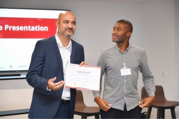 Presentation of a certificate to a participant of the GROWTH Hillingdon Business Support Programme.