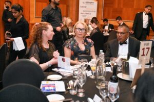 Hillingdon Business Awards 2025. Men and women sitting at their table waiting for the awards ceremony to start.