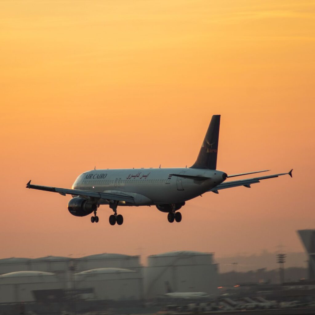 Image of a plane taking off in the sunset at Heathrow Airport